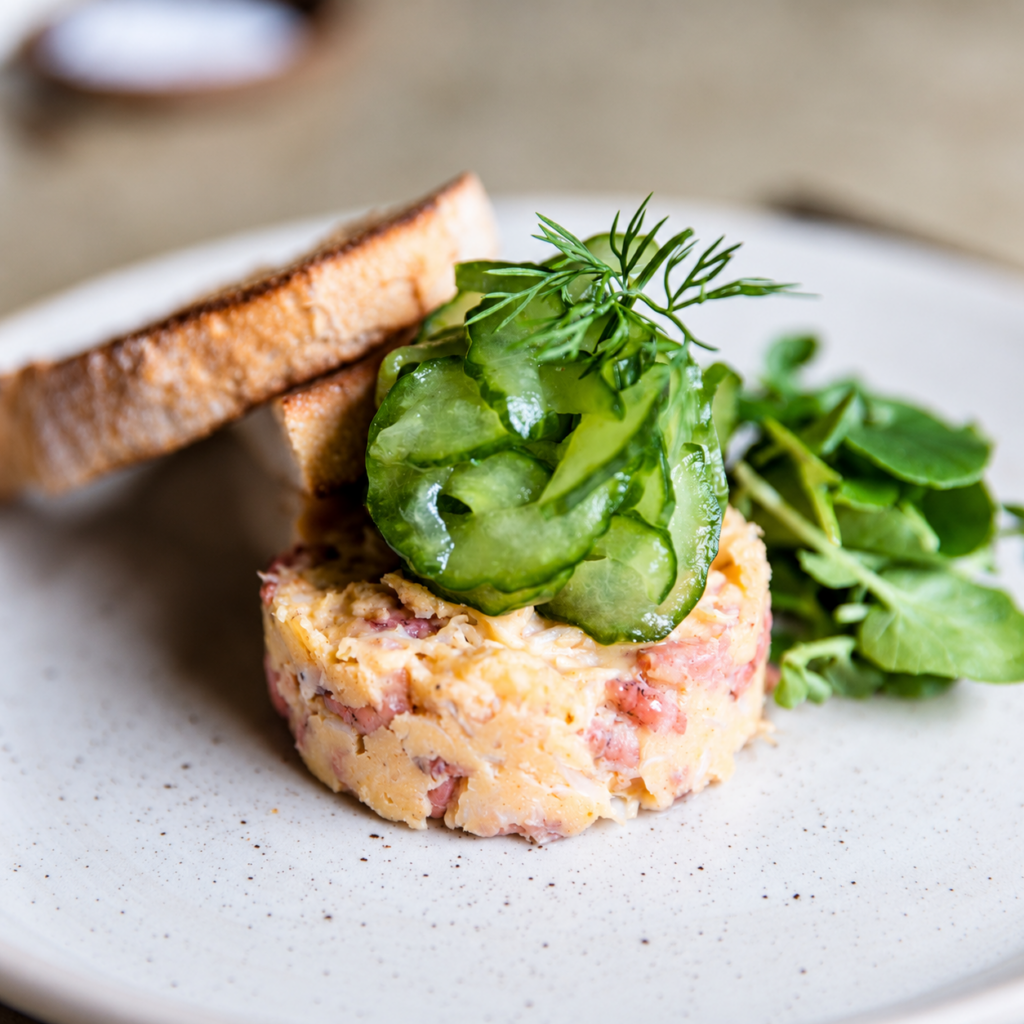 Starter topped with cucumber ribbons and fresh herbs, served with toasted bread at The Butchers Arms.